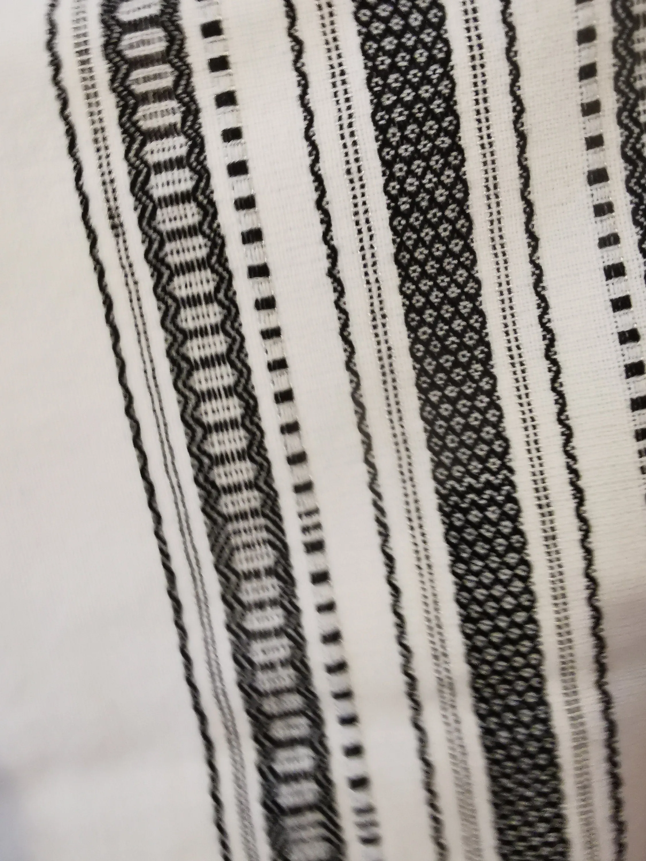 Woven scarf with geometric black on white pattern